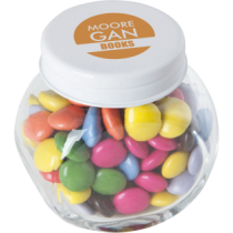Kleine glazen pot gevuld met ca. 40 gr. choco carletties gekleurd deksel
